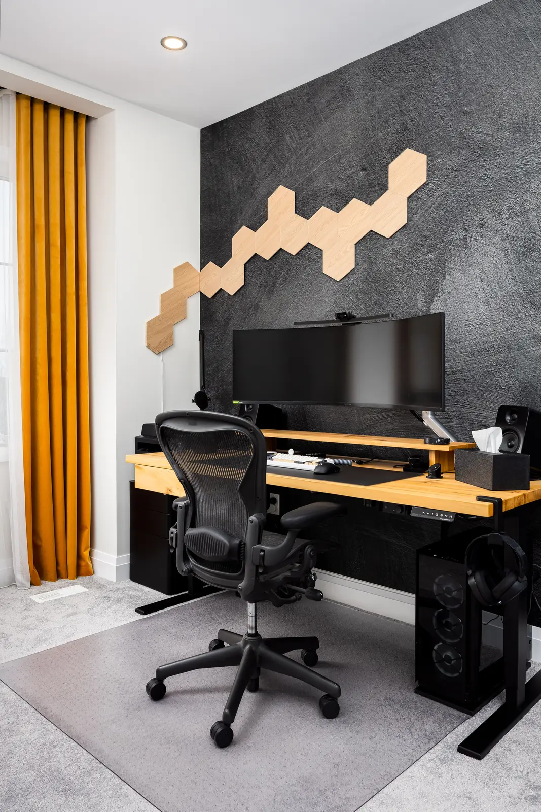 Home office in a Richmond Hill townhouse, with a wood desk, a dark wall, and hexagonal lights