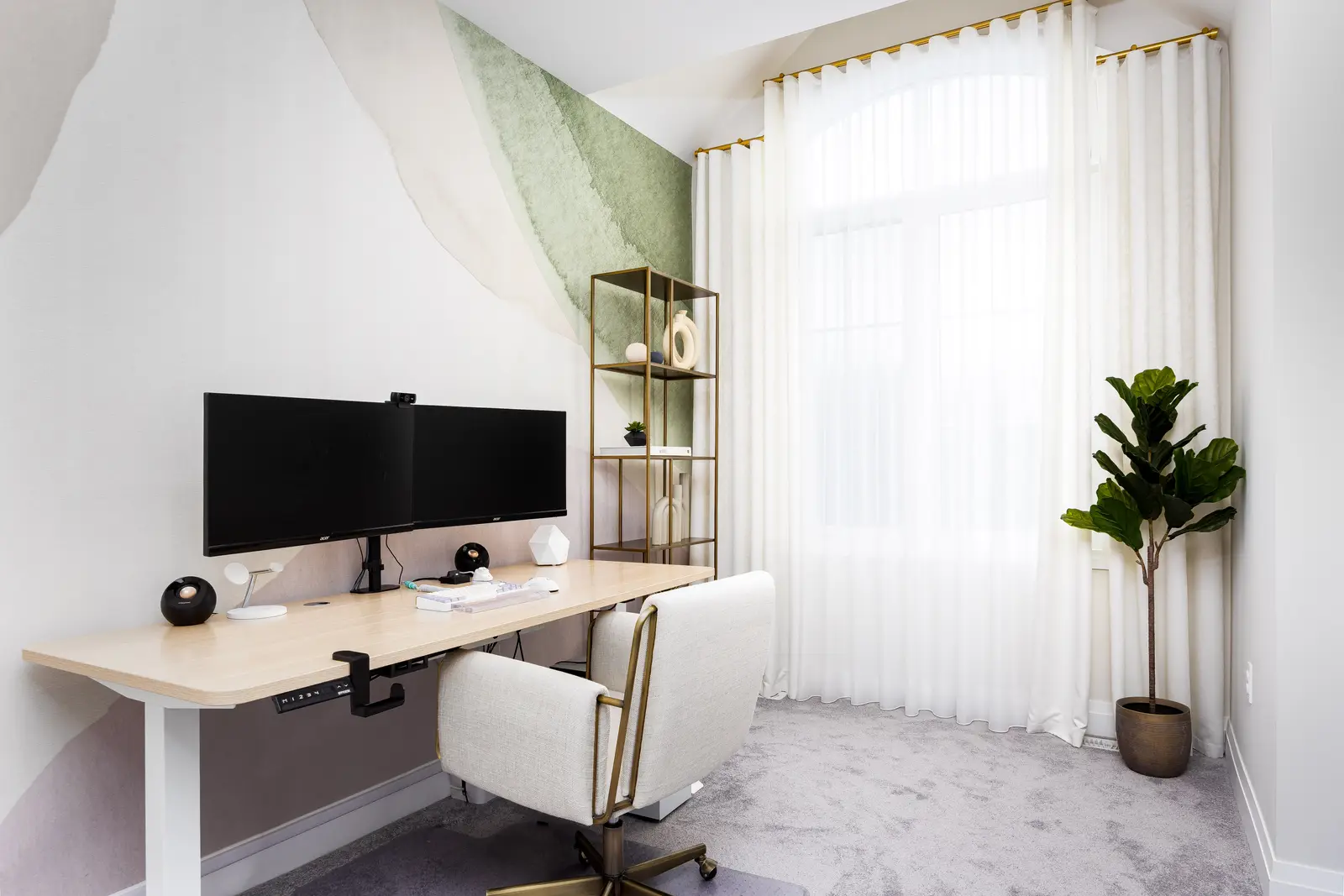 Office desk in a Richmond Hill townhouse, beside a green mural, white curtains, and a fiddle-leaf fig