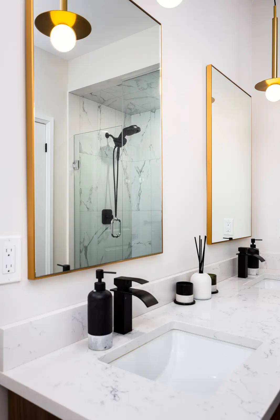 Bathroom vanity in a Richmond Hill townhouse, with a marble counter, a black faucet, and a glass shower