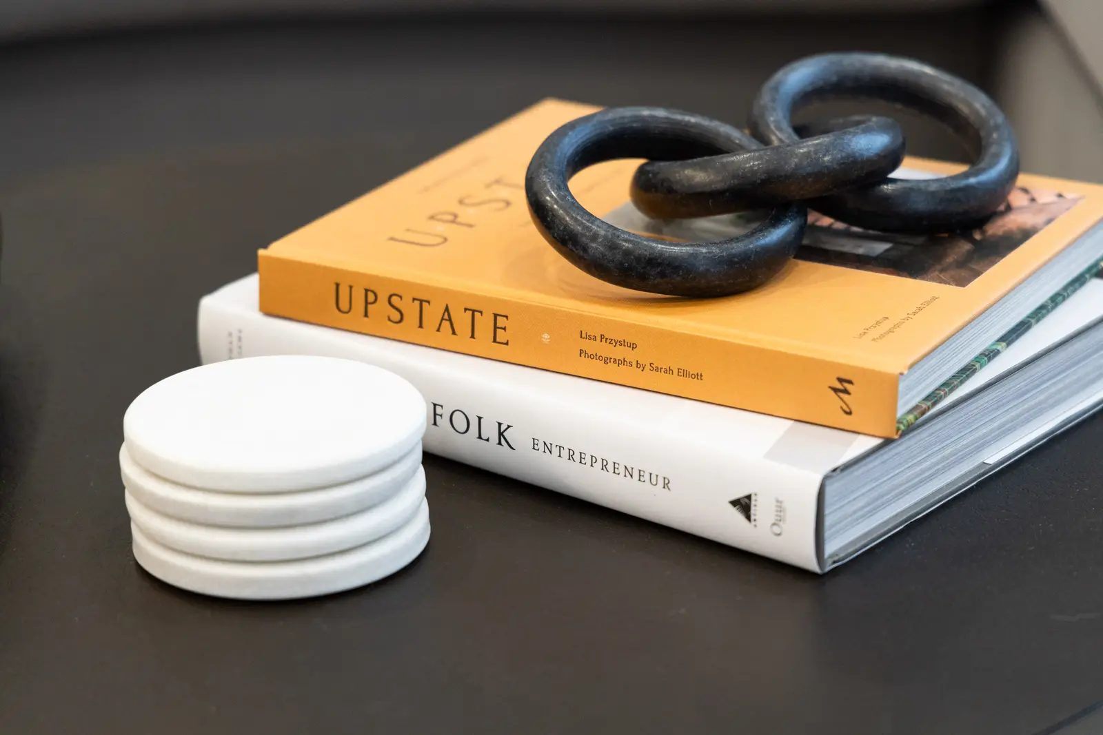 Books and a dark chain sculpture on the coffee table in a Richmond Hill townhouse