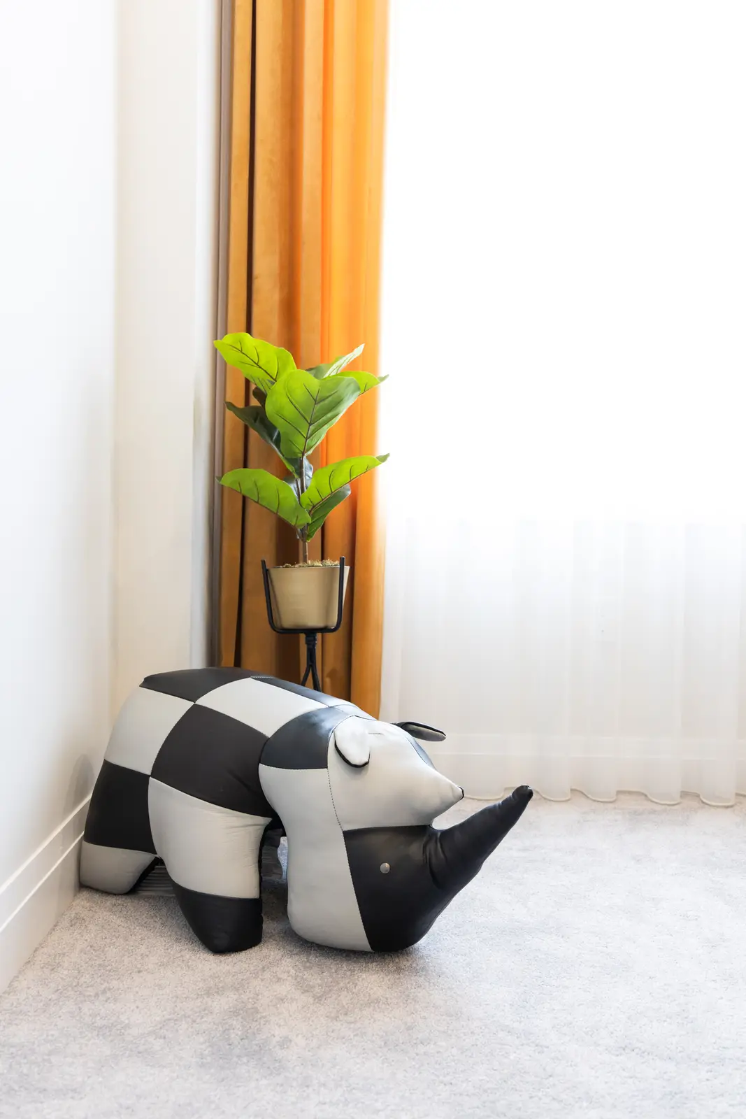 Office corner in a Richmond Hill townhouse, with mustard curtains and a black-and-white ottoman