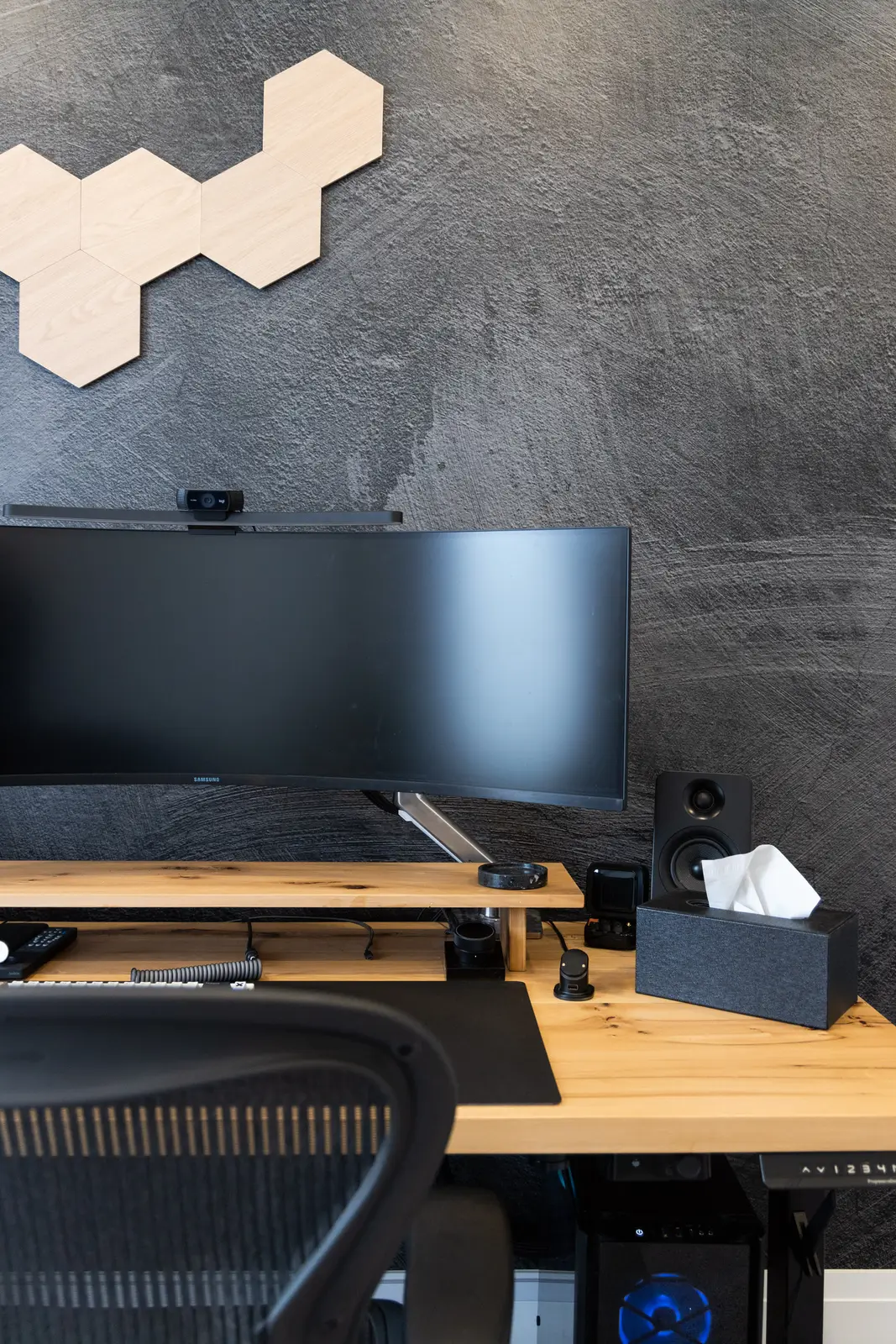Wood desk and hexagonal lights on the dark office wall in a Richmond Hill townhouse
