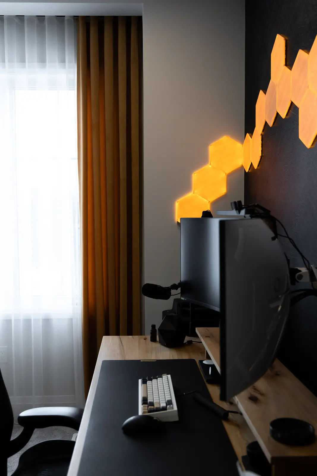 Office desk in a Richmond Hill townhouse, with mustard curtains and hexagonal lights