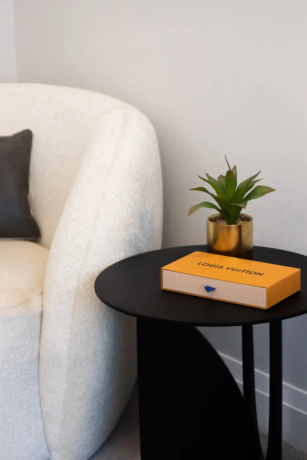 White chair and black side table in the bedroom of a Richmond Hill townhouse