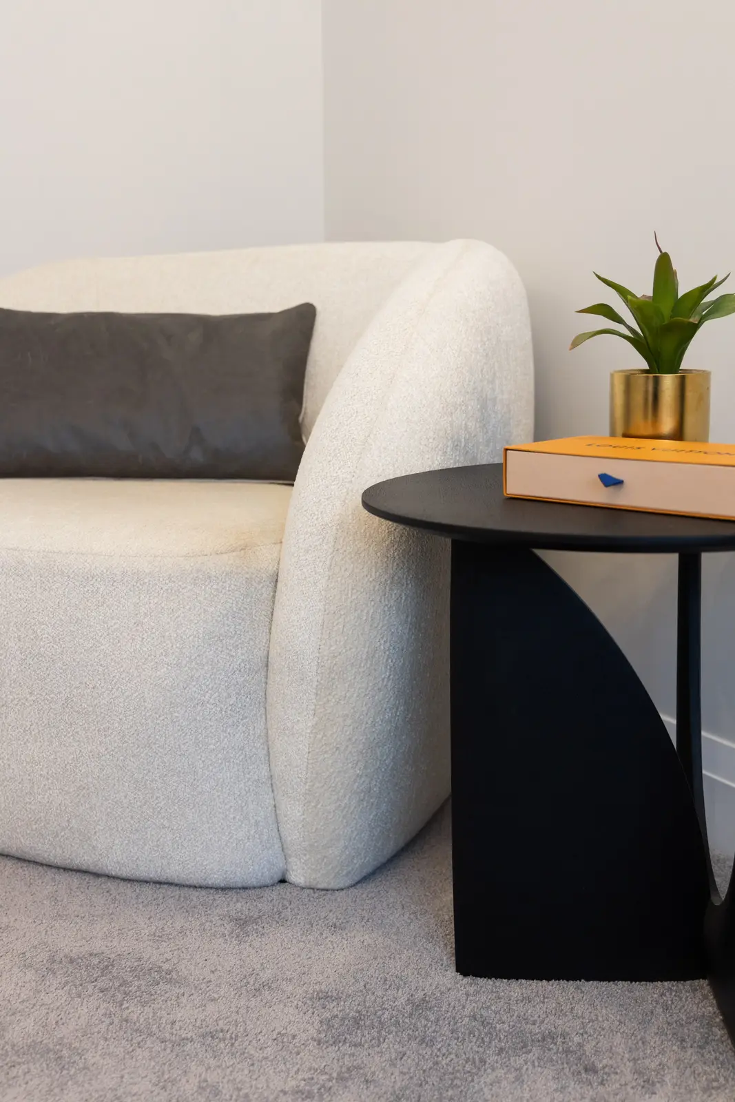 White chair and black side table on grey carpet in a Richmond Hill townhouse bedroom