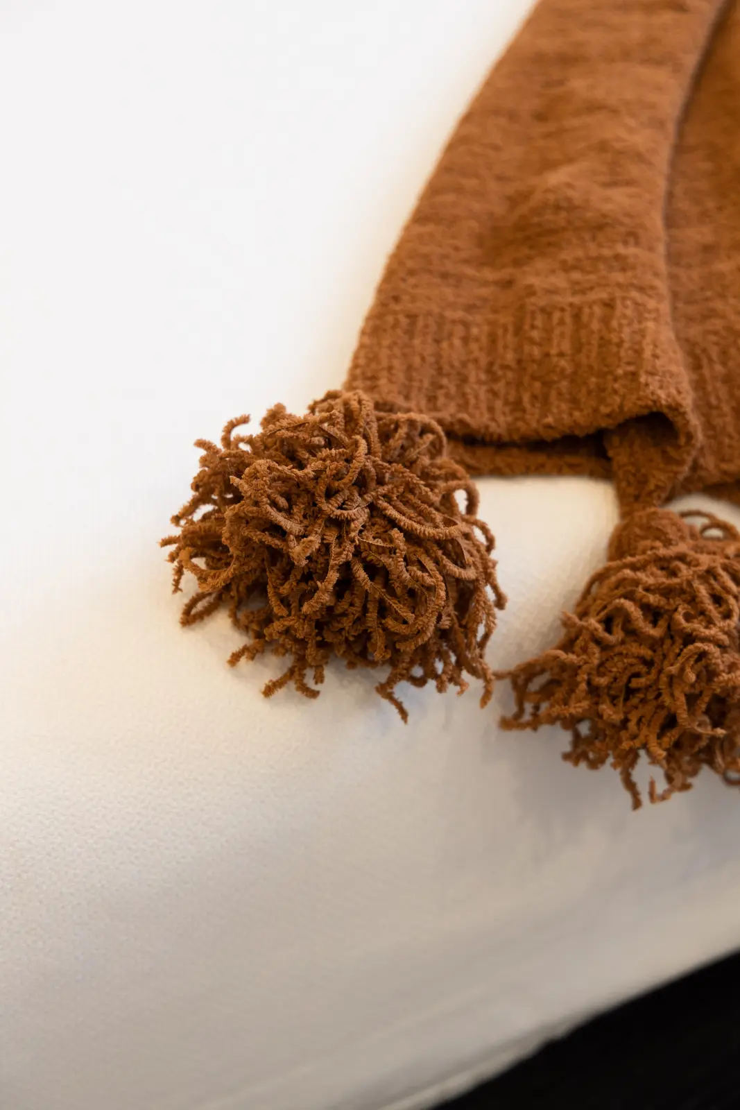 Brown throw with tassels on the white bed in a Richmond Hill townhouse