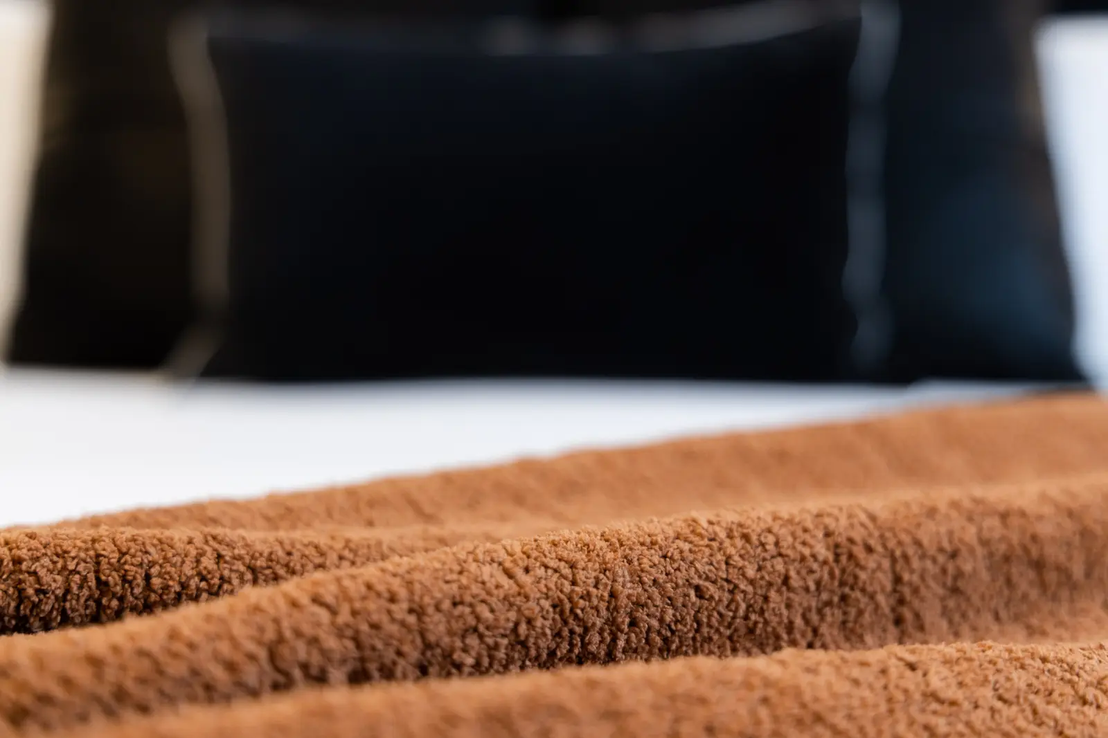 Brown throw and black pillows on the bed in a Richmond Hill townhouse