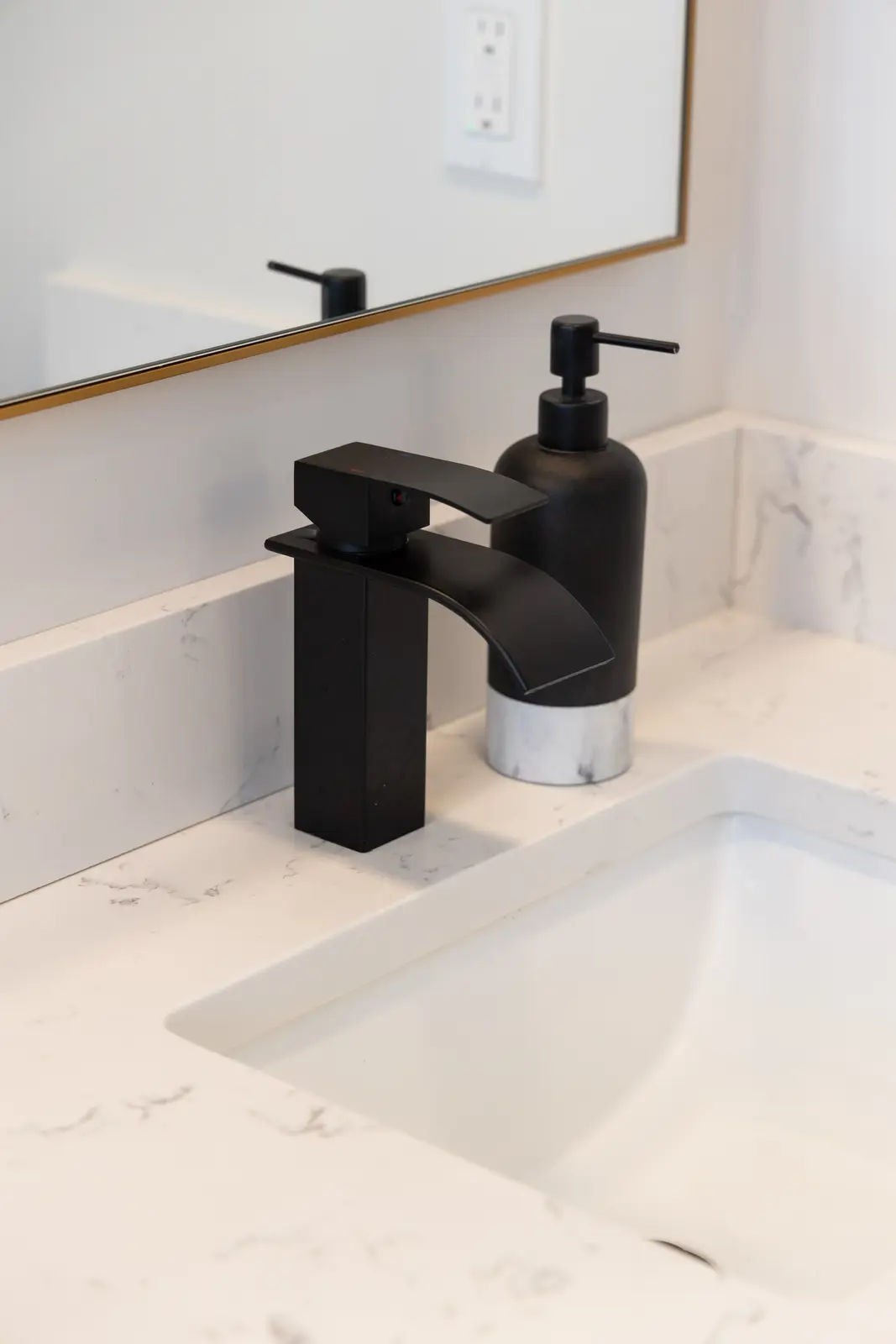 Black faucet on the marble bathroom counter in a Richmond Hill townhouse