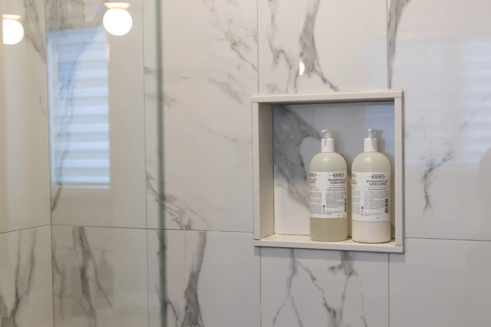 Marble shower niche with bottles in a Richmond Hill townhouse