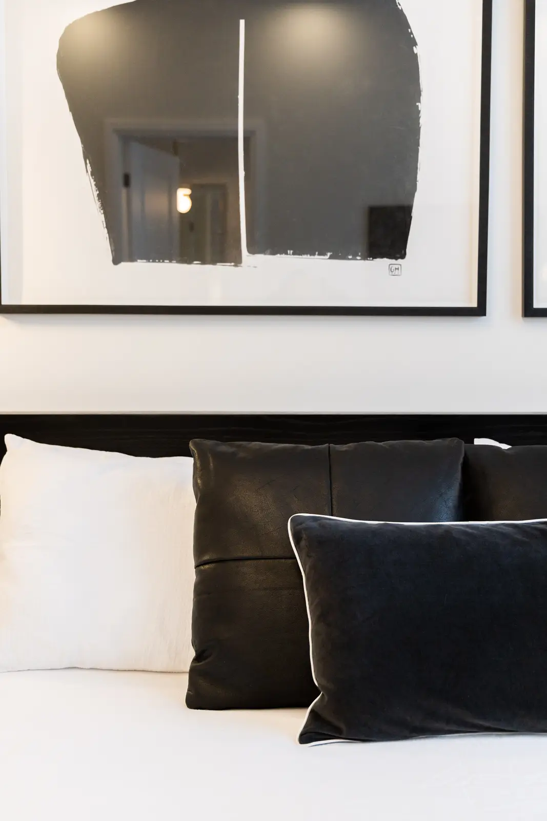 Black pillows on the white bed in a Richmond Hill townhouse