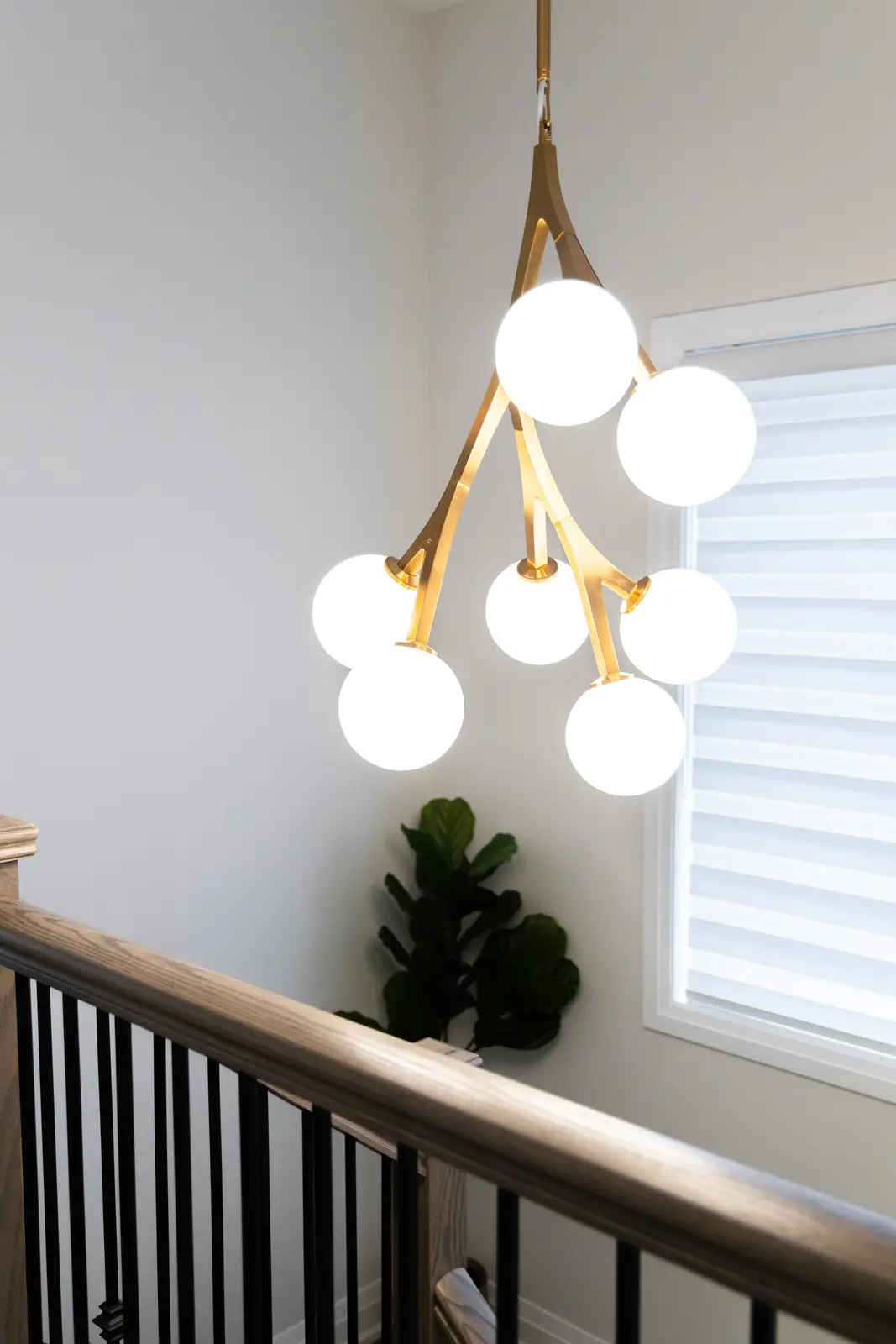 Gold branch chandelier above the stair in a Richmond Hill townhouse
