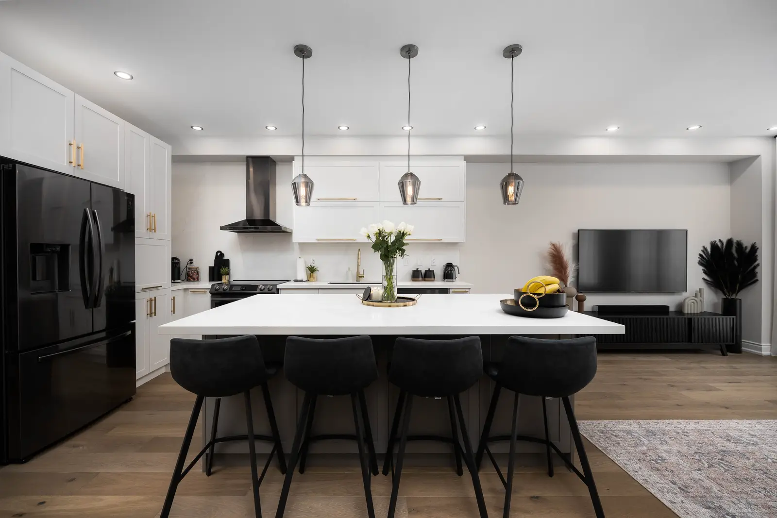 Interior of the Bristlewood Crescent renovation in Vaughan, with white cabinetry, warm wood floors, and black fittings.