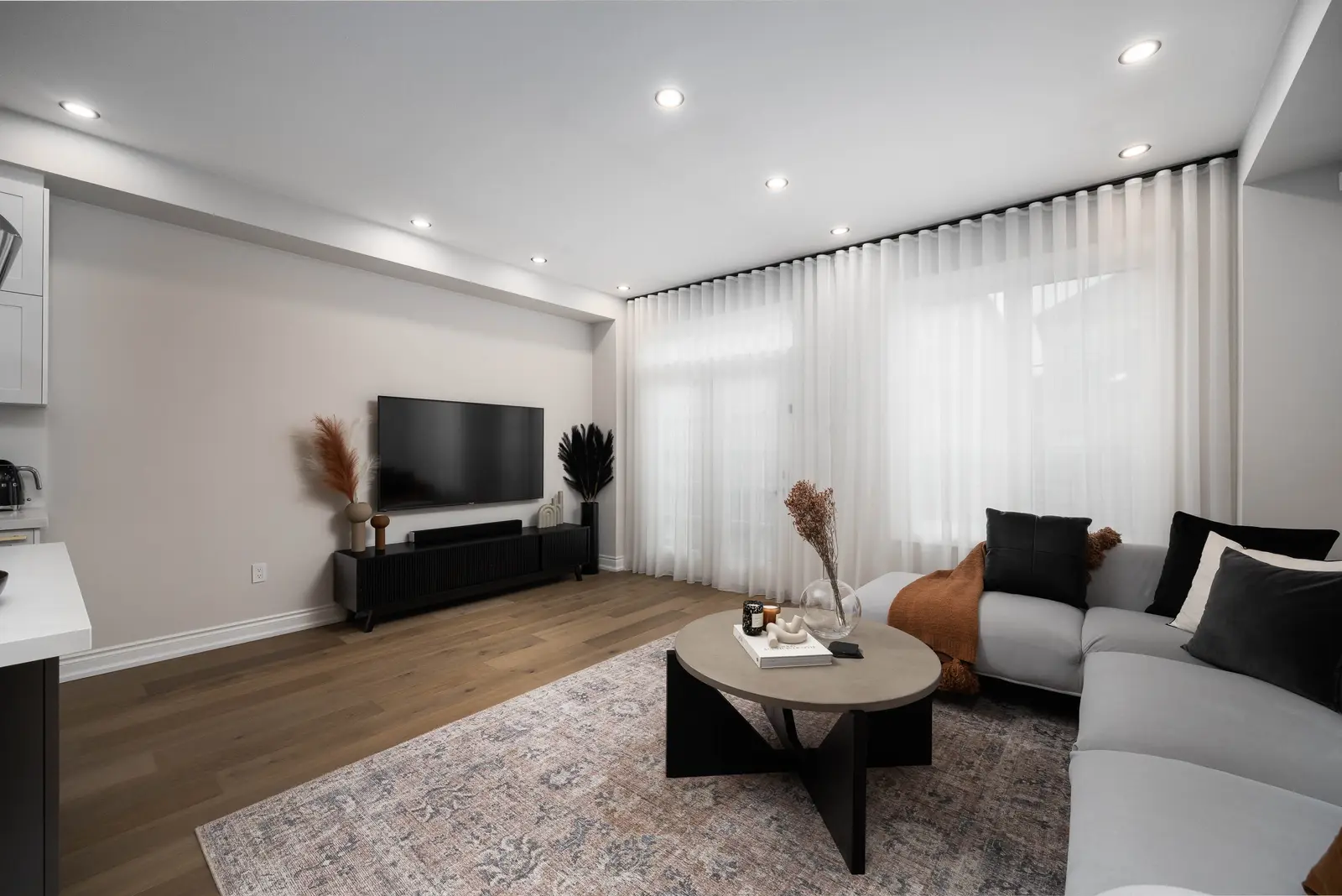 Interior of the Bristlewood Crescent renovation in Vaughan, with white cabinetry, warm wood floors, and black fittings.