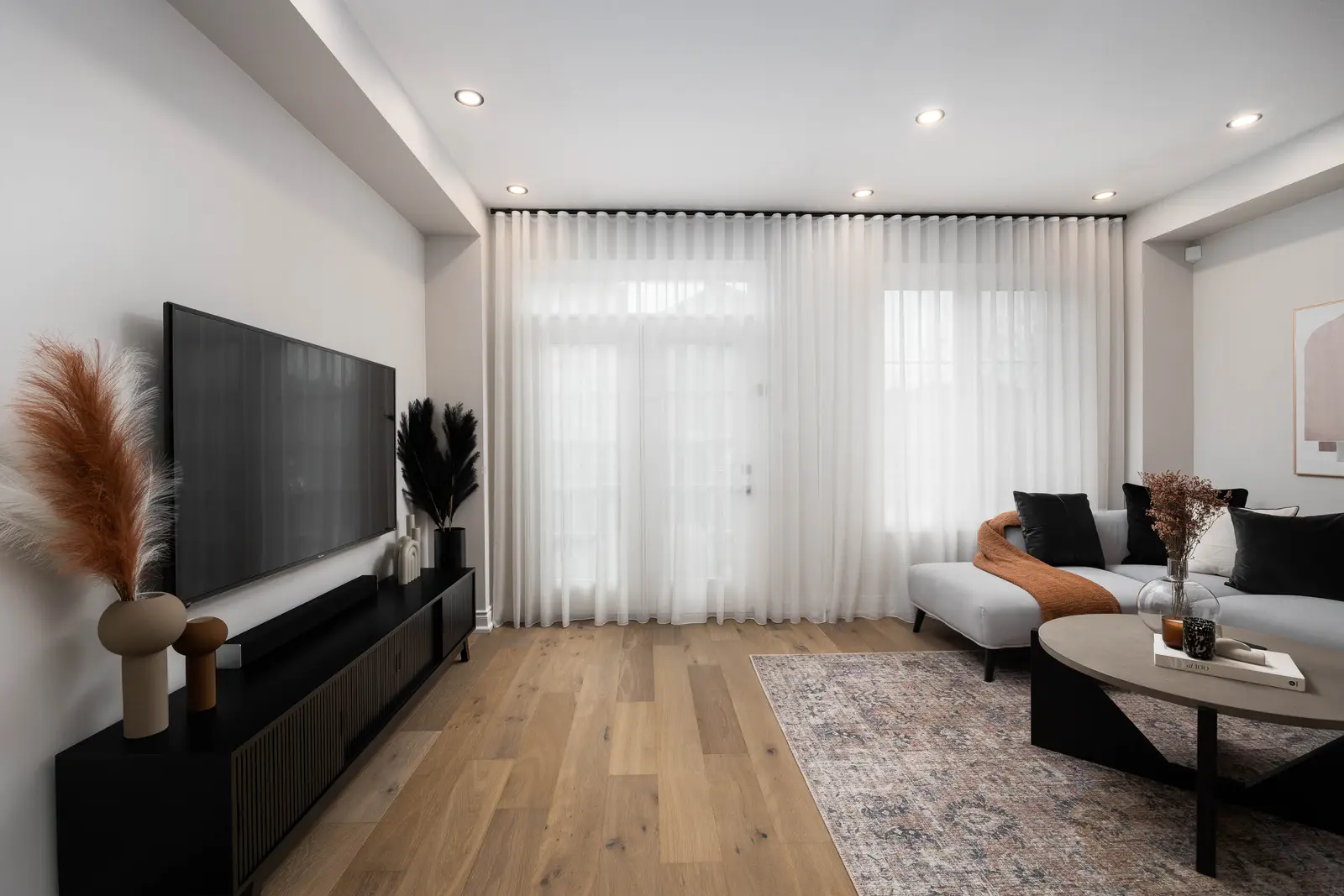 Interior of the Bristlewood Crescent renovation in Vaughan, with white cabinetry, warm wood floors, and black fittings.