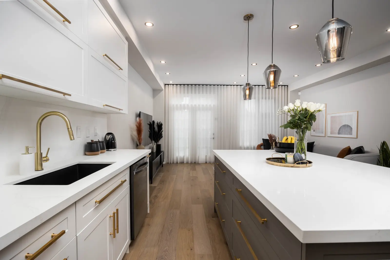 Interior of the Bristlewood Crescent renovation in Vaughan, with white cabinetry, warm wood floors, and black fittings.