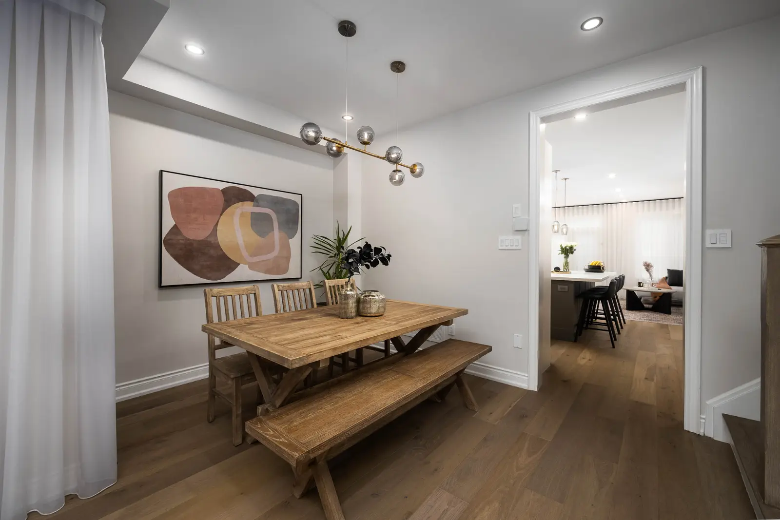 Interior of the Bristlewood Crescent renovation in Vaughan, with white cabinetry, warm wood floors, and black fittings.