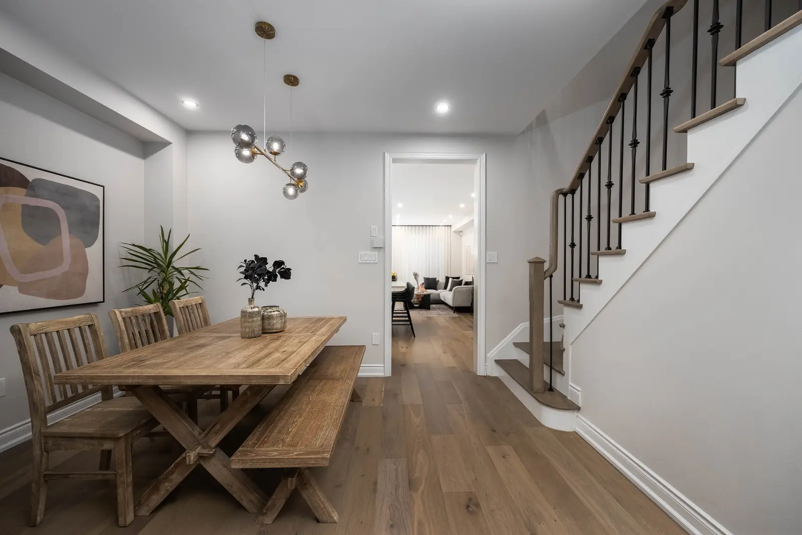Interior of the Bristlewood Crescent renovation in Vaughan, with white cabinetry, warm wood floors, and black fittings.