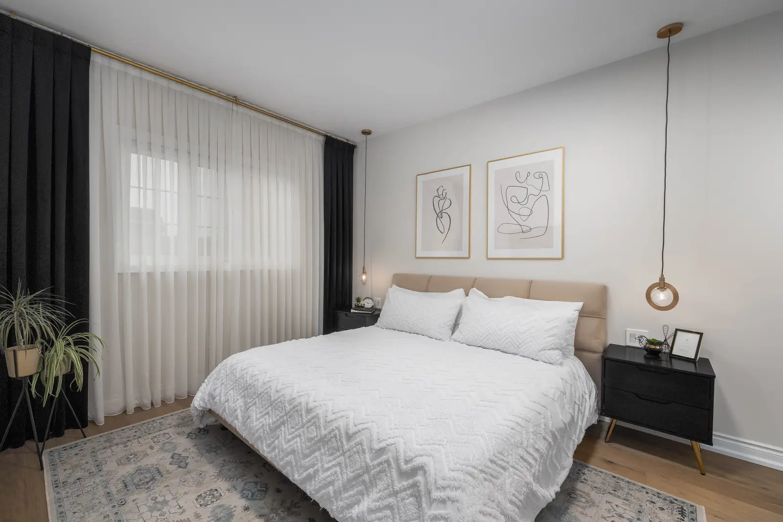 Interior of the Bristlewood Crescent renovation in Vaughan, with white cabinetry, warm wood floors, and black fittings.