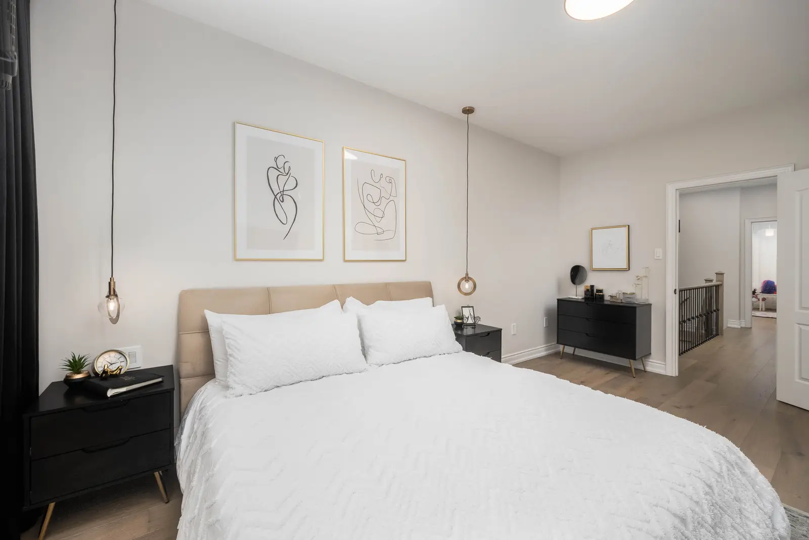 Interior of the Bristlewood Crescent renovation in Vaughan, with white cabinetry, warm wood floors, and black fittings.