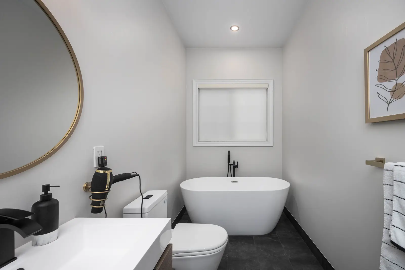 Interior of the Bristlewood Crescent renovation in Vaughan, with white cabinetry, warm wood floors, and black fittings.