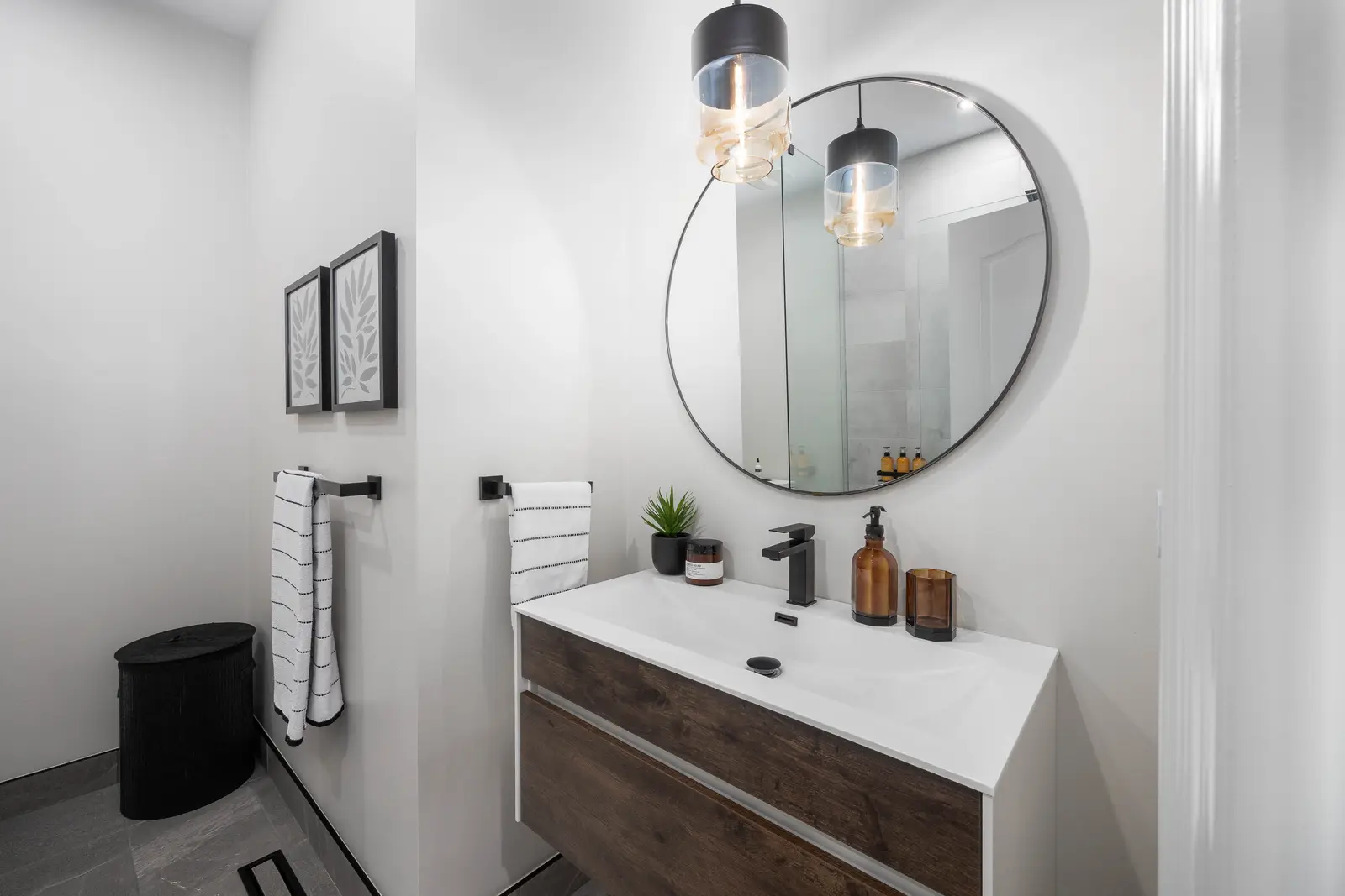 Interior of the Bristlewood Crescent renovation in Vaughan, with white cabinetry, warm wood floors, and black fittings.