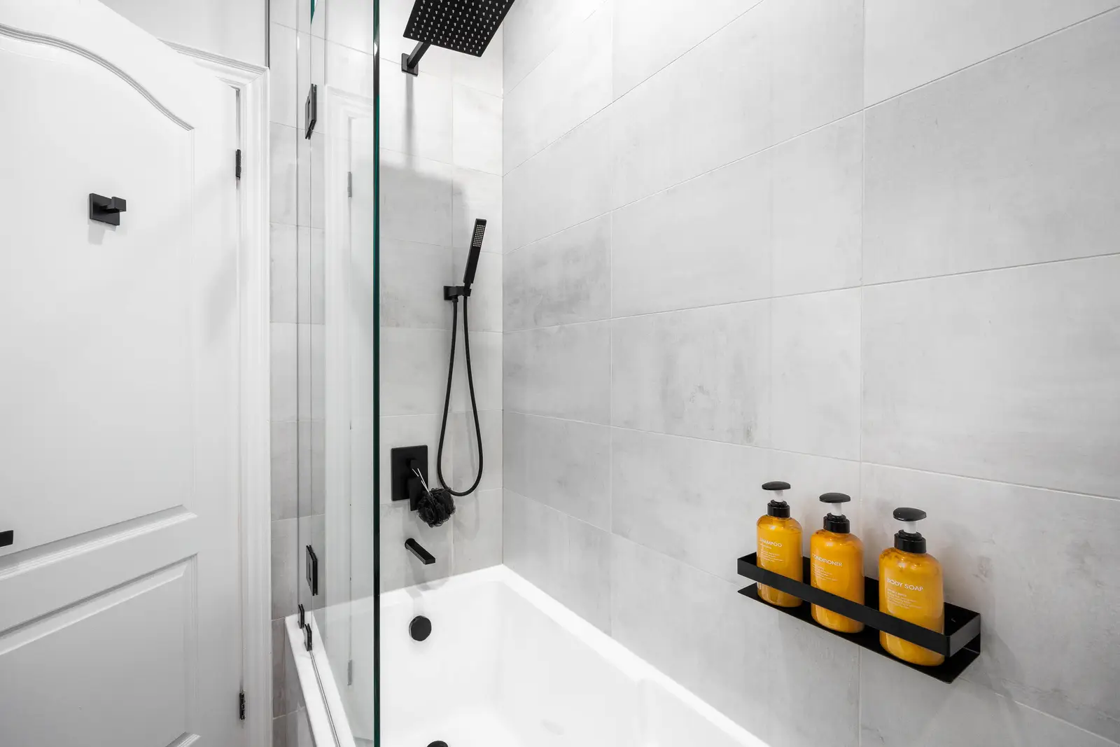 Interior of the Bristlewood Crescent renovation in Vaughan, with white cabinetry, warm wood floors, and black fittings.