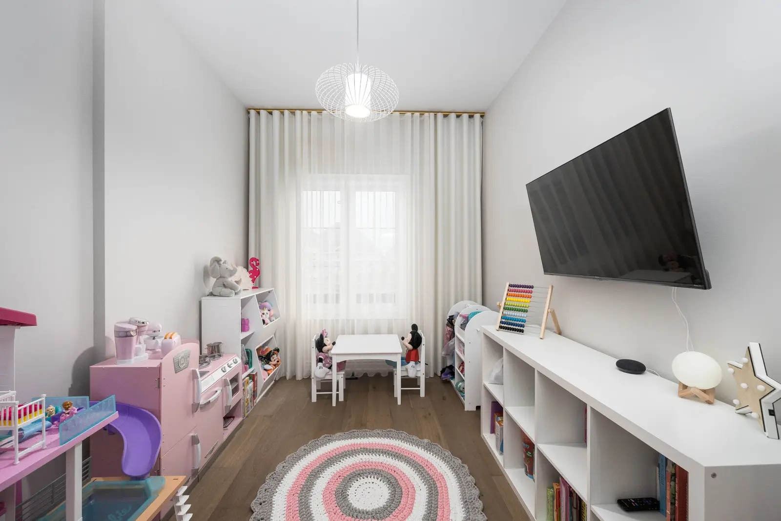 Interior of the Bristlewood Crescent renovation in Vaughan, with white cabinetry, warm wood floors, and black fittings.