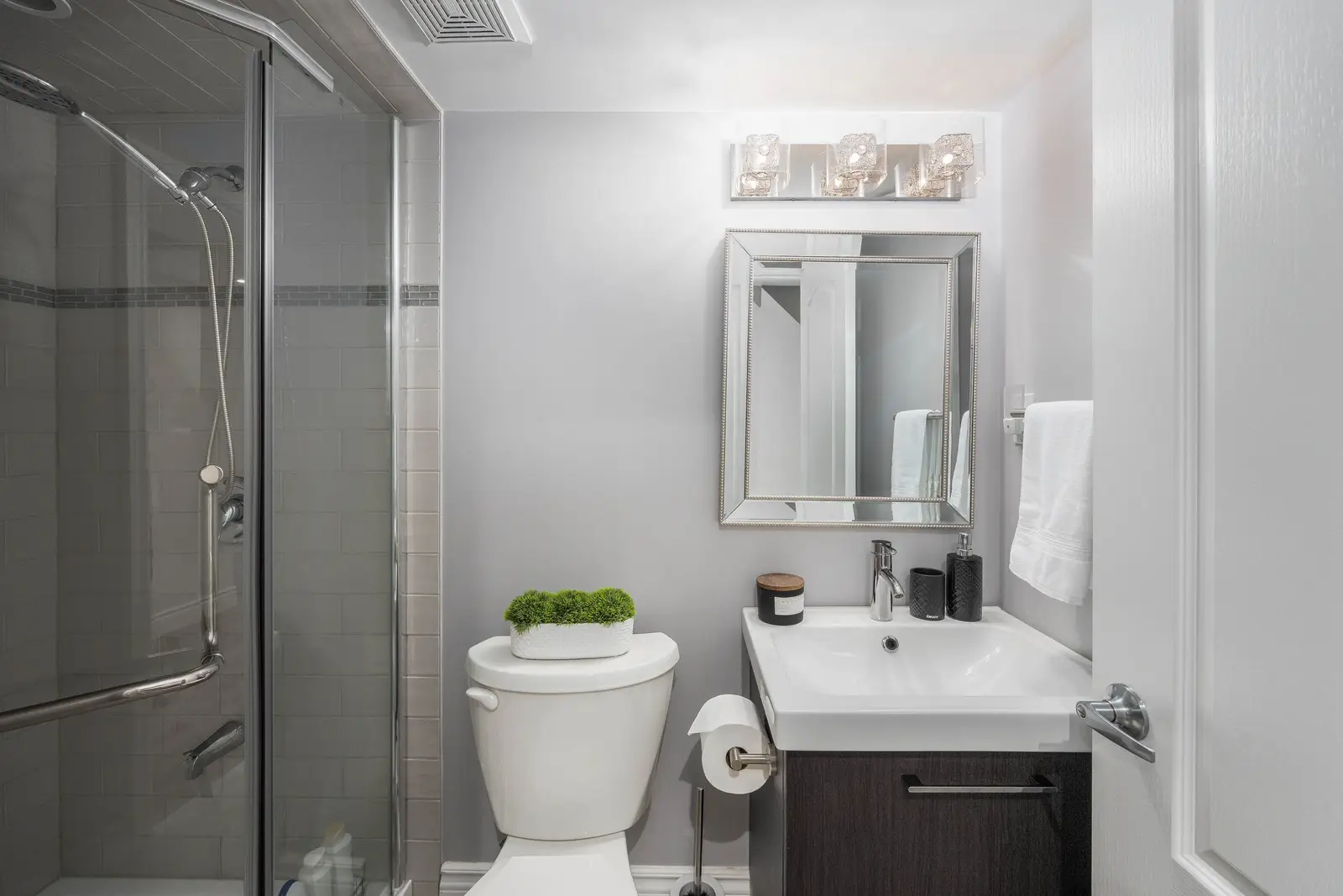Interior of the Bristlewood Crescent renovation in Vaughan, with white cabinetry, warm wood floors, and black fittings.
