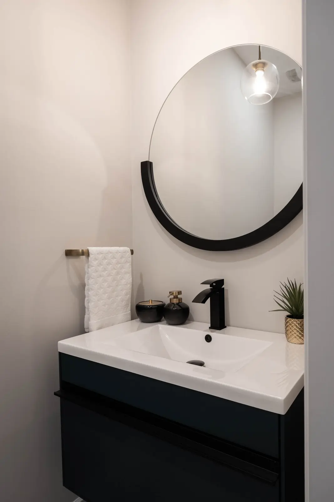 Interior of the Bristlewood Crescent renovation in Vaughan, with white cabinetry, warm wood floors, and black fittings.