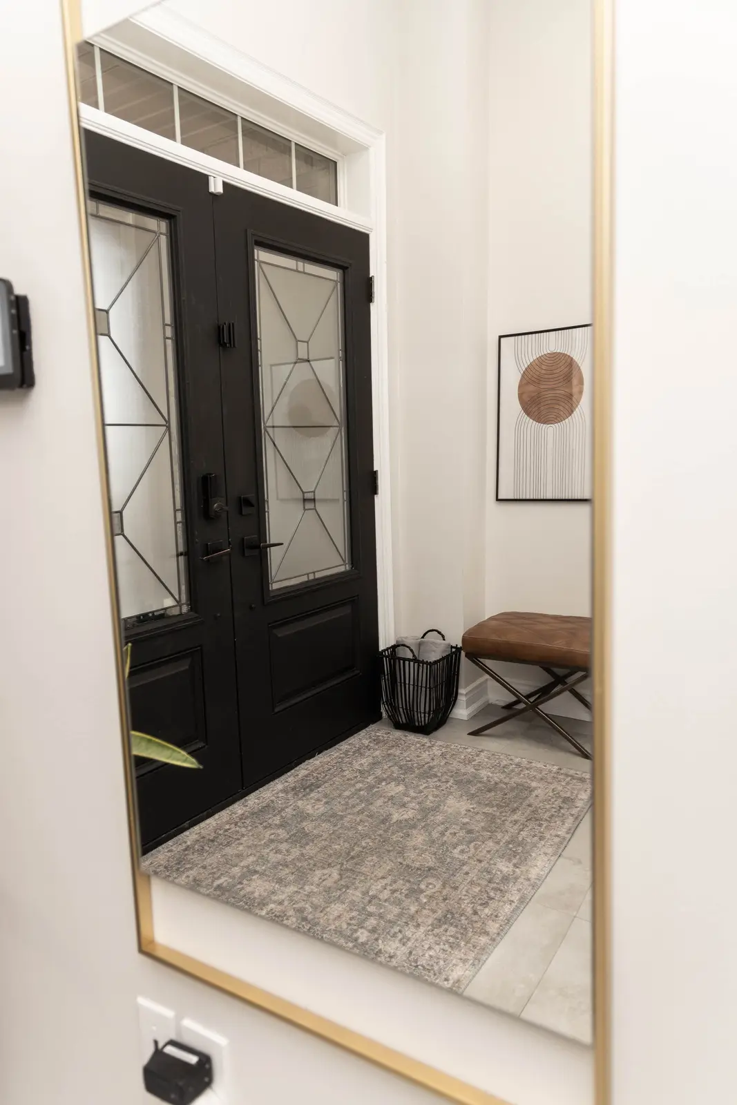 Interior of the Bristlewood Crescent renovation in Vaughan, with white cabinetry, warm wood floors, and black fittings.