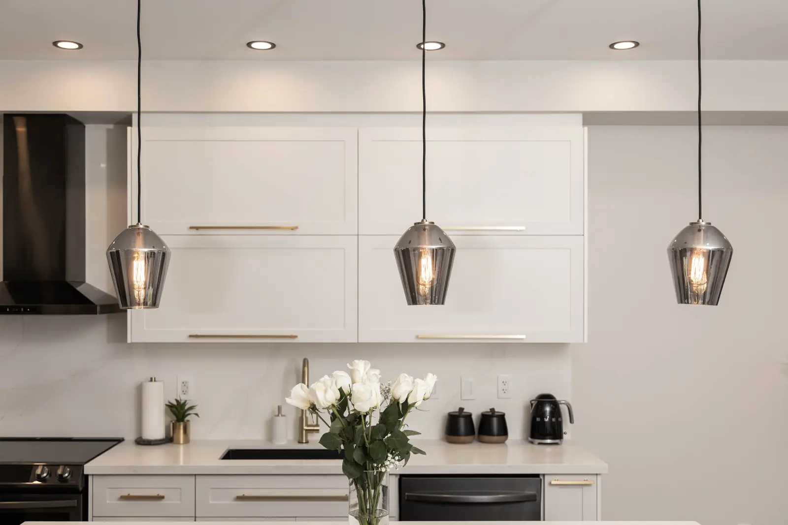 Interior of the Bristlewood Crescent renovation in Vaughan, with white cabinetry, warm wood floors, and black fittings.