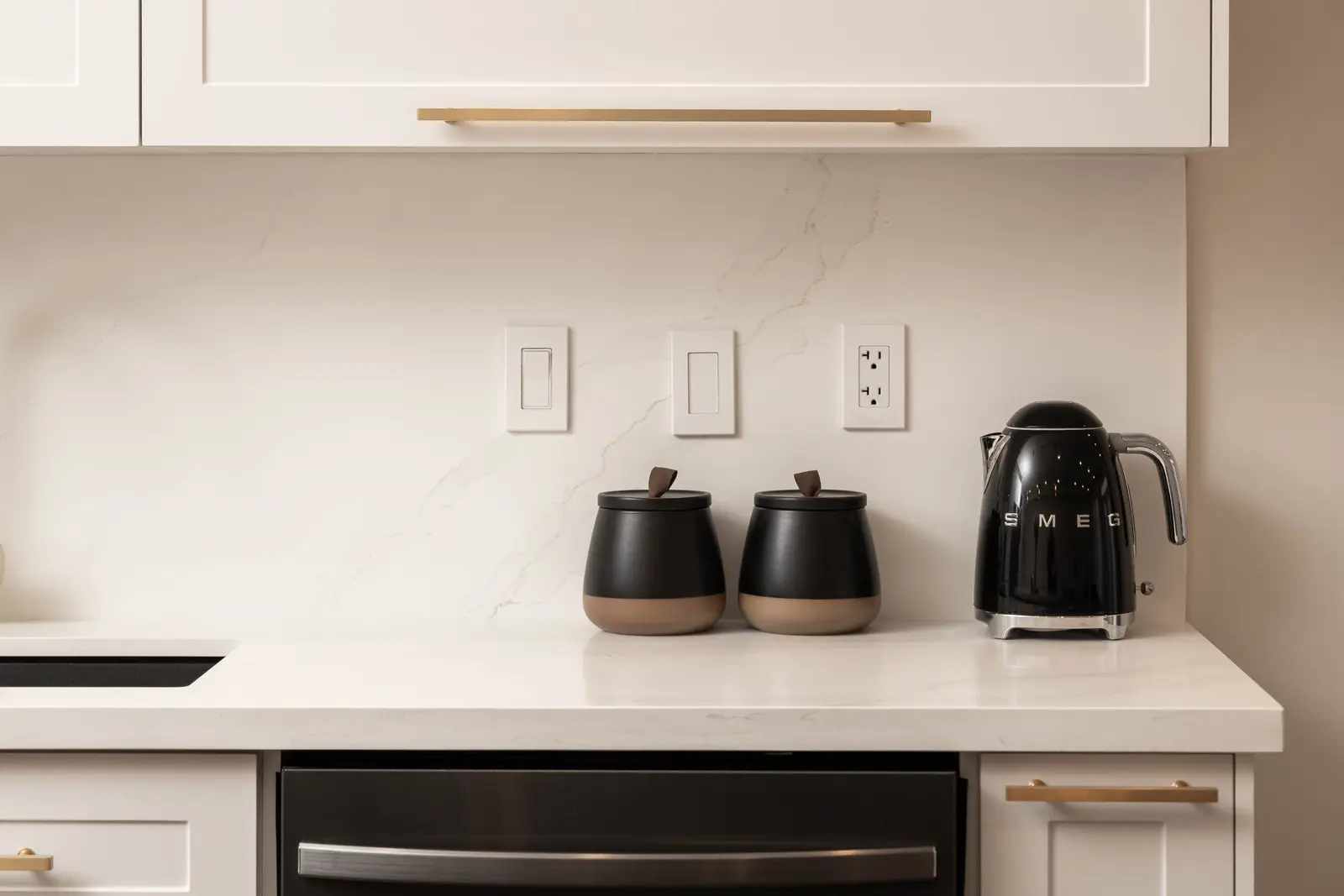 Interior of the Bristlewood Crescent renovation in Vaughan, with white cabinetry, warm wood floors, and black fittings.