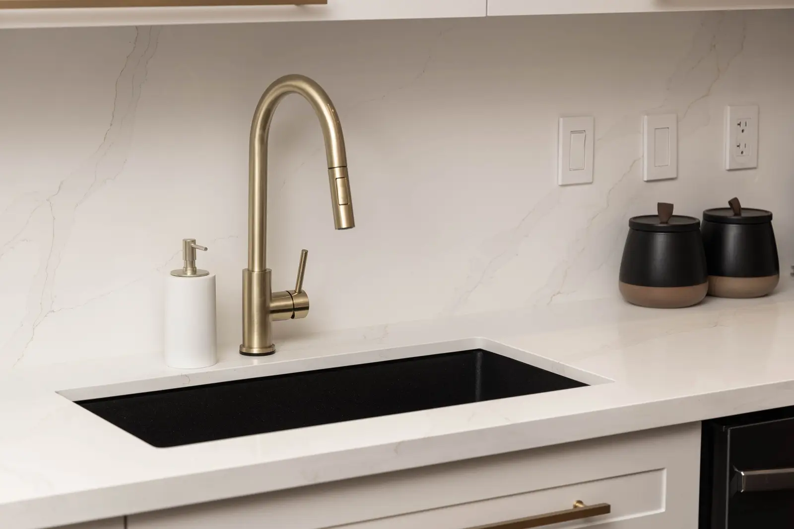 Interior of the Bristlewood Crescent renovation in Vaughan, with white cabinetry, warm wood floors, and black fittings.