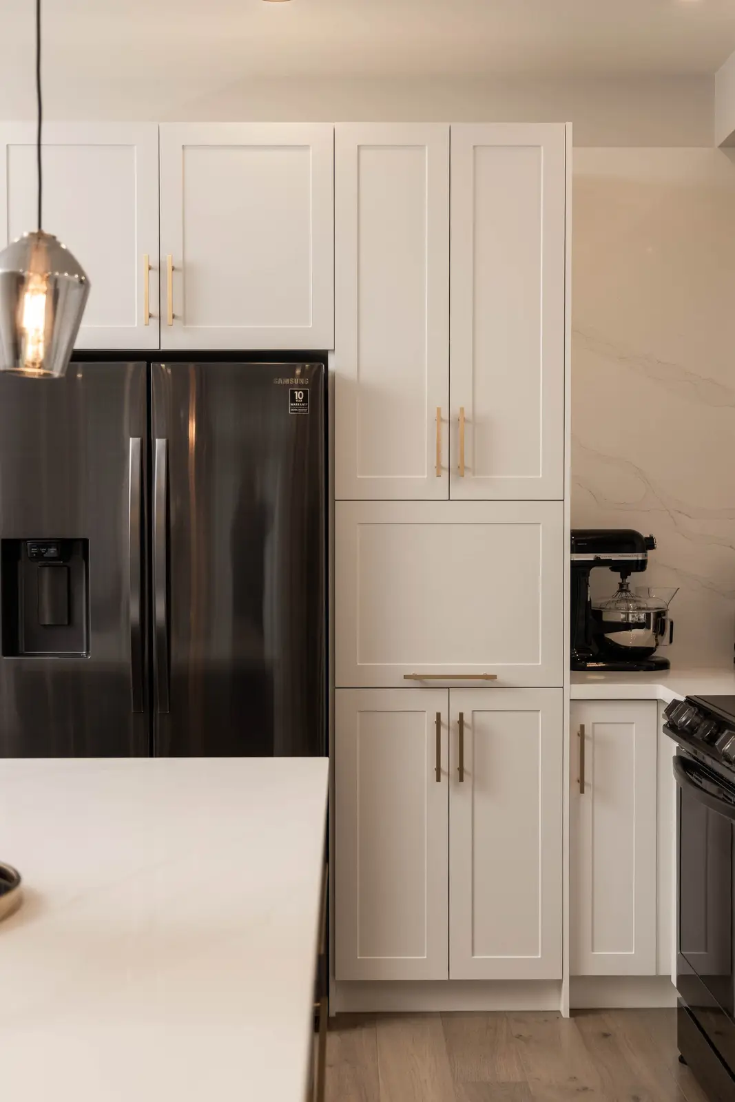 Interior of the Bristlewood Crescent renovation in Vaughan, with white cabinetry, warm wood floors, and black fittings.