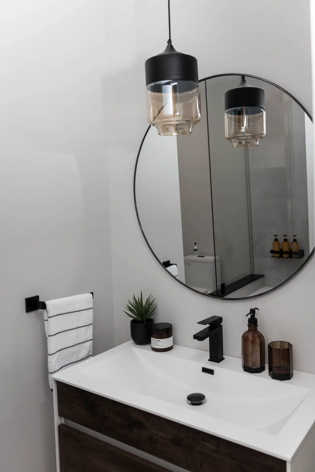 Interior of the Bristlewood Crescent renovation in Vaughan, with white cabinetry, warm wood floors, and black fittings.