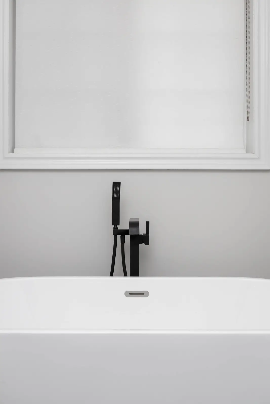 Interior of the Bristlewood Crescent renovation in Vaughan, with white cabinetry, warm wood floors, and black fittings.