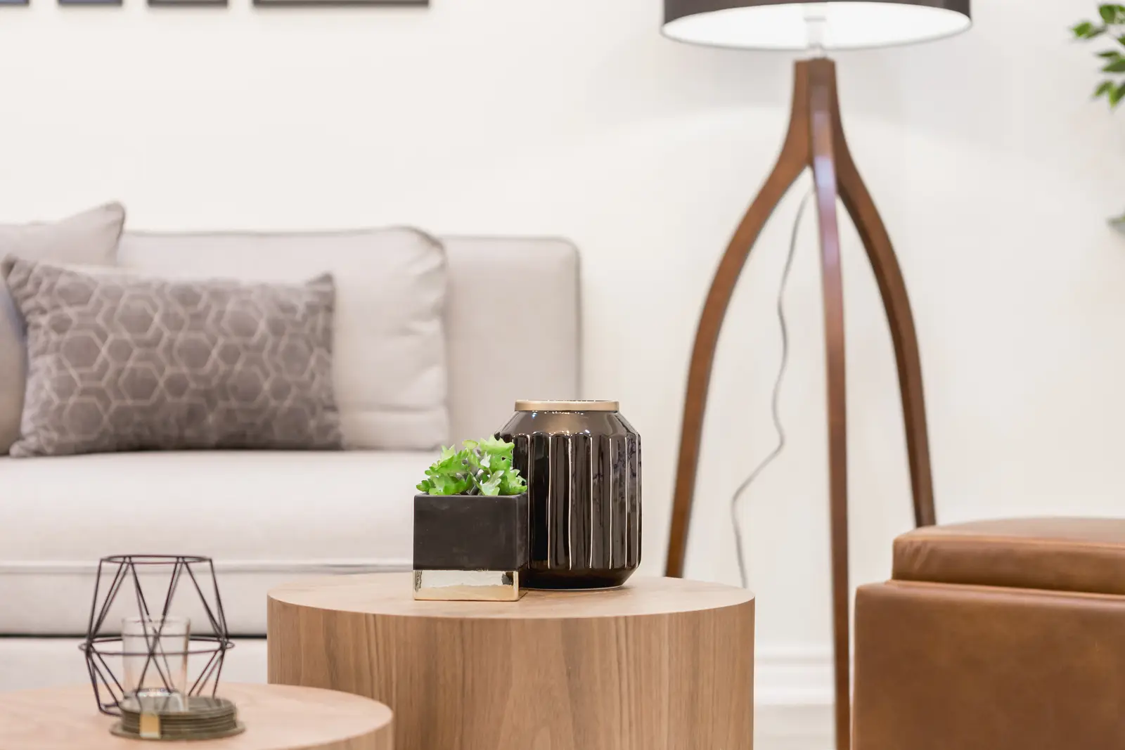 Finished room in a downtown Toronto basement renovation, with white walls, light wood floors, and grey upholstery.