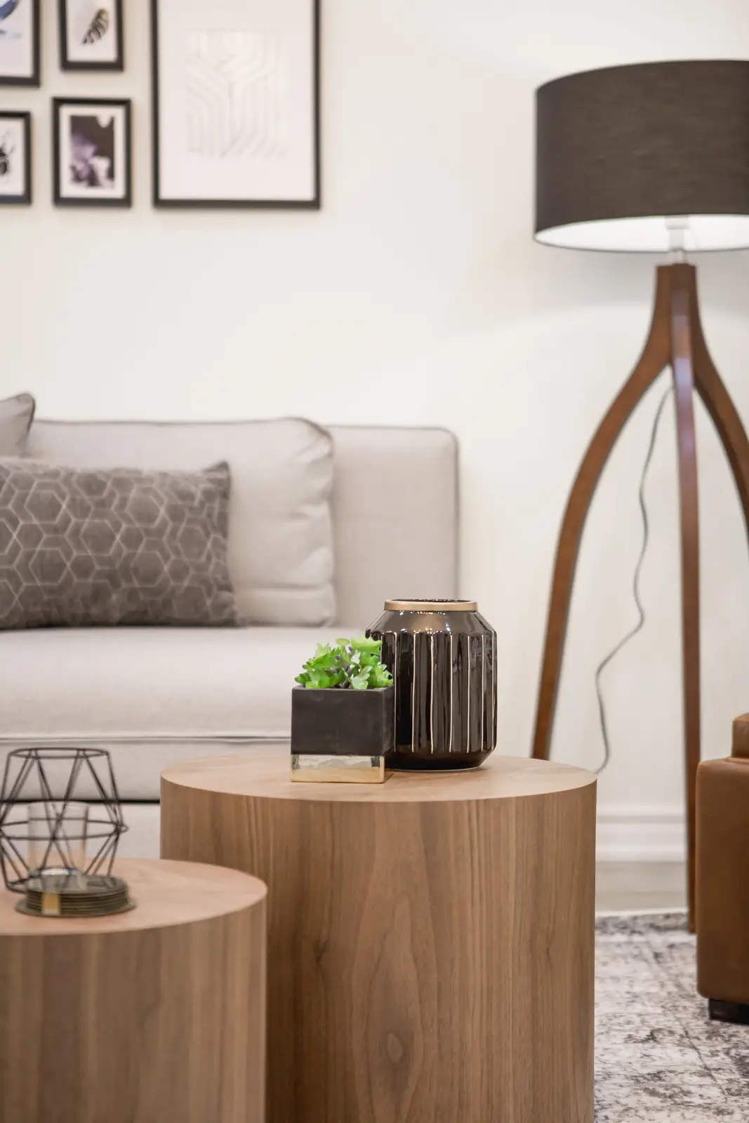 Finished room in a downtown Toronto basement renovation, with white walls, light wood floors, and grey upholstery.