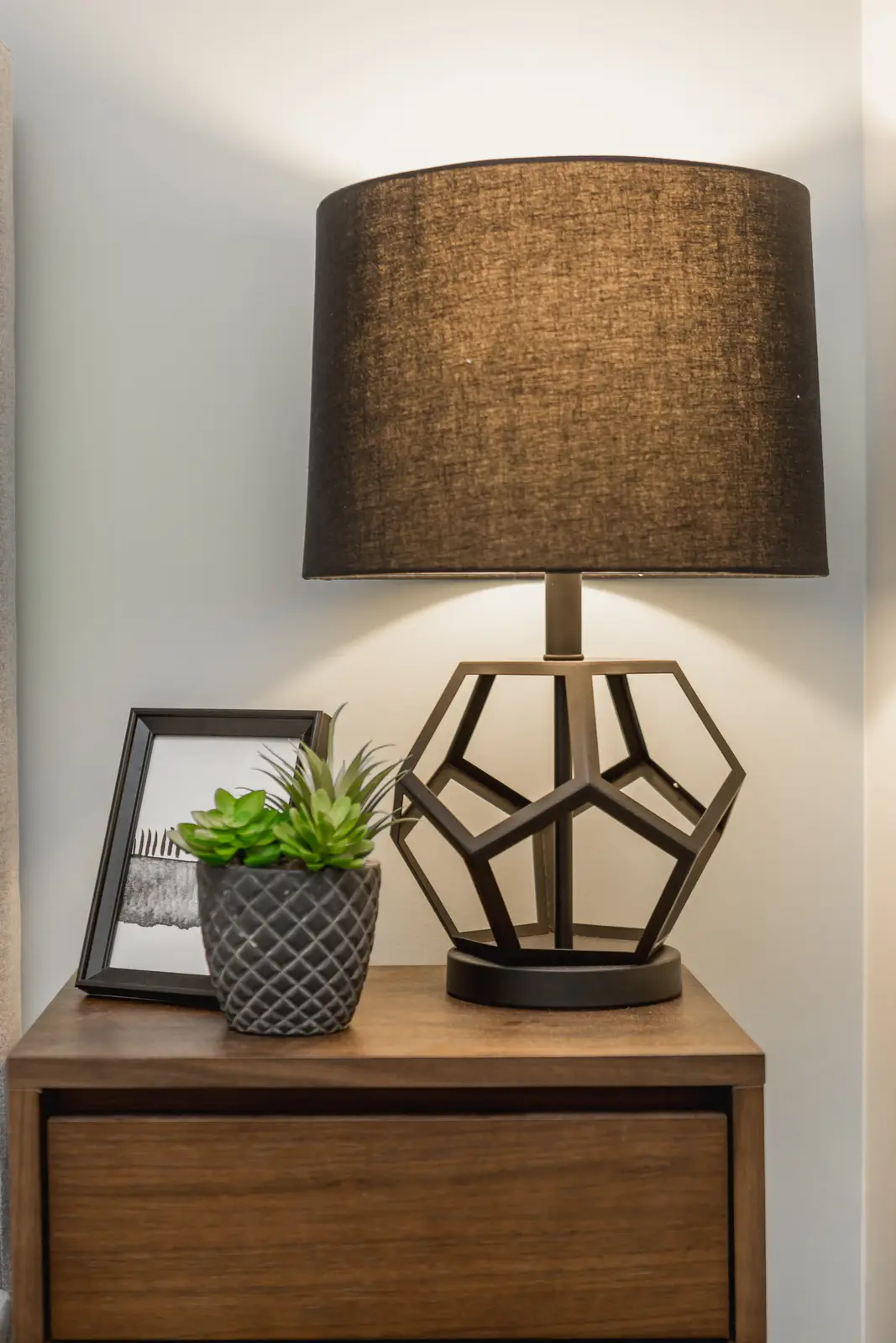 Finished room in a downtown Toronto basement renovation, with white walls, light wood floors, and grey upholstery.