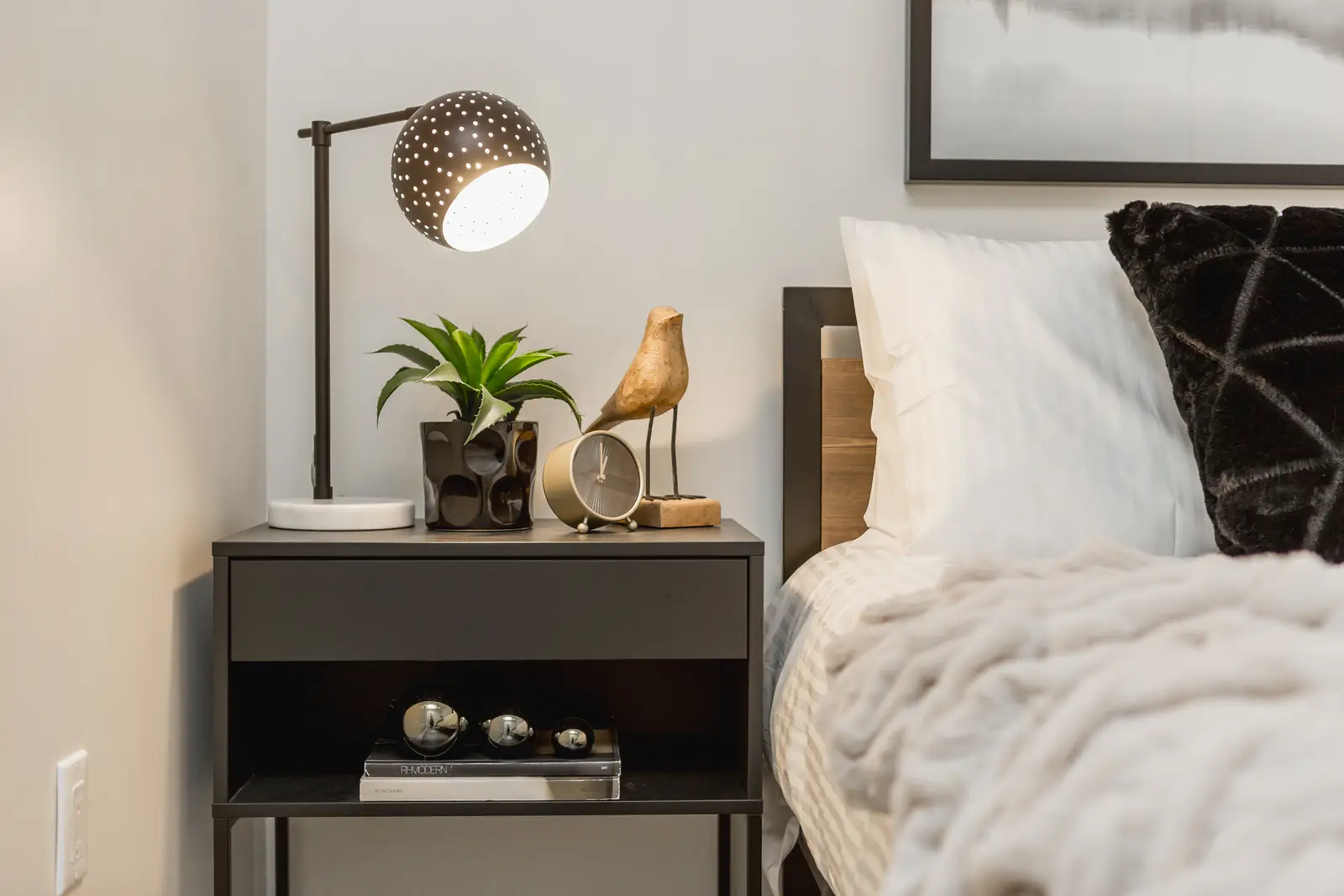 Finished room in a downtown Toronto basement renovation, with white walls, light wood floors, and grey upholstery.