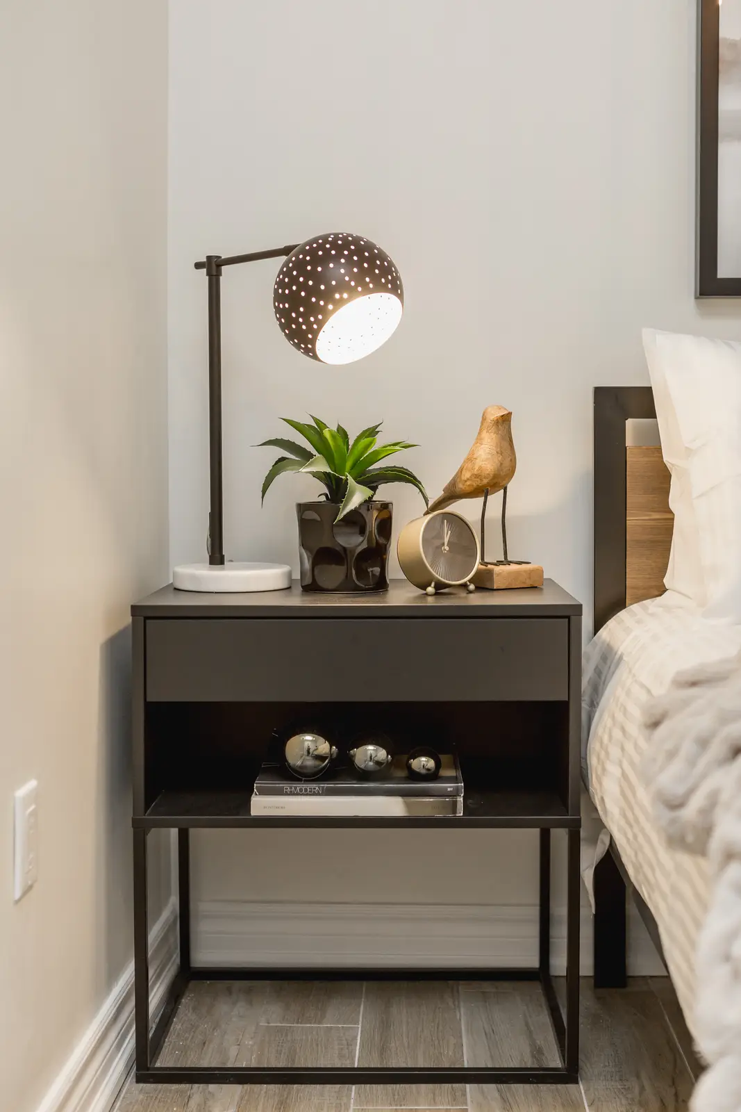 Finished room in a downtown Toronto basement renovation, with white walls, light wood floors, and grey upholstery.