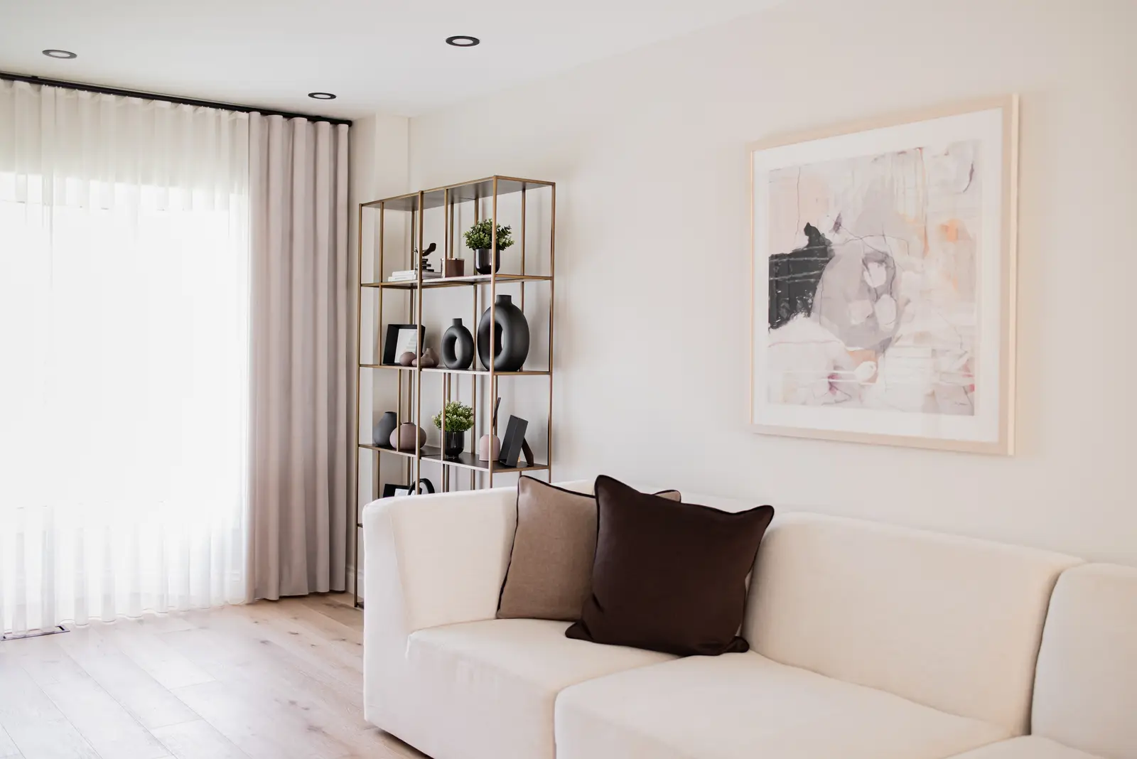 Interior of a Thornhill house renovation, with sage cabinetry, light wood floors, walnut, and brass fittings.