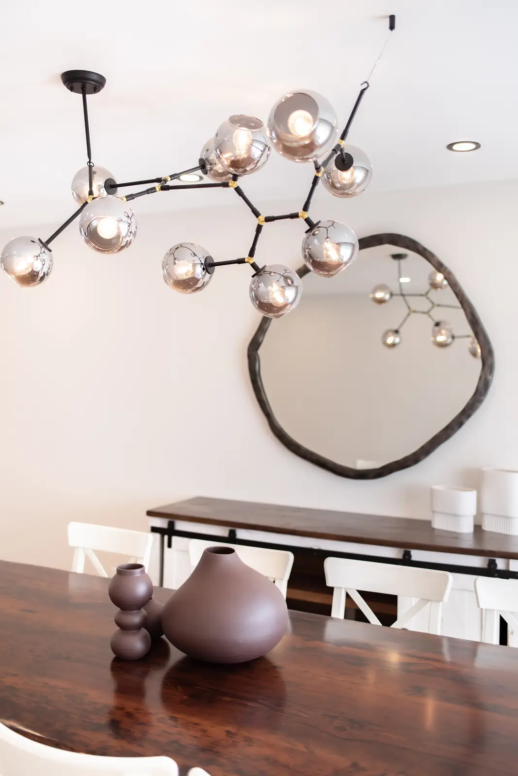 Interior of a Thornhill house renovation, with sage cabinetry, light wood floors, walnut, and brass fittings.