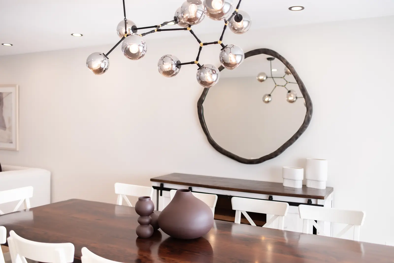 Interior of a Thornhill house renovation, with sage cabinetry, light wood floors, walnut, and brass fittings.