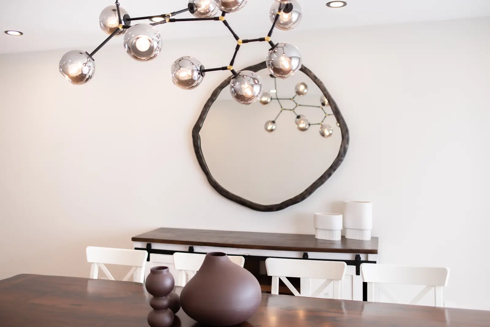 Interior of a Thornhill house renovation, with sage cabinetry, light wood floors, walnut, and brass fittings.