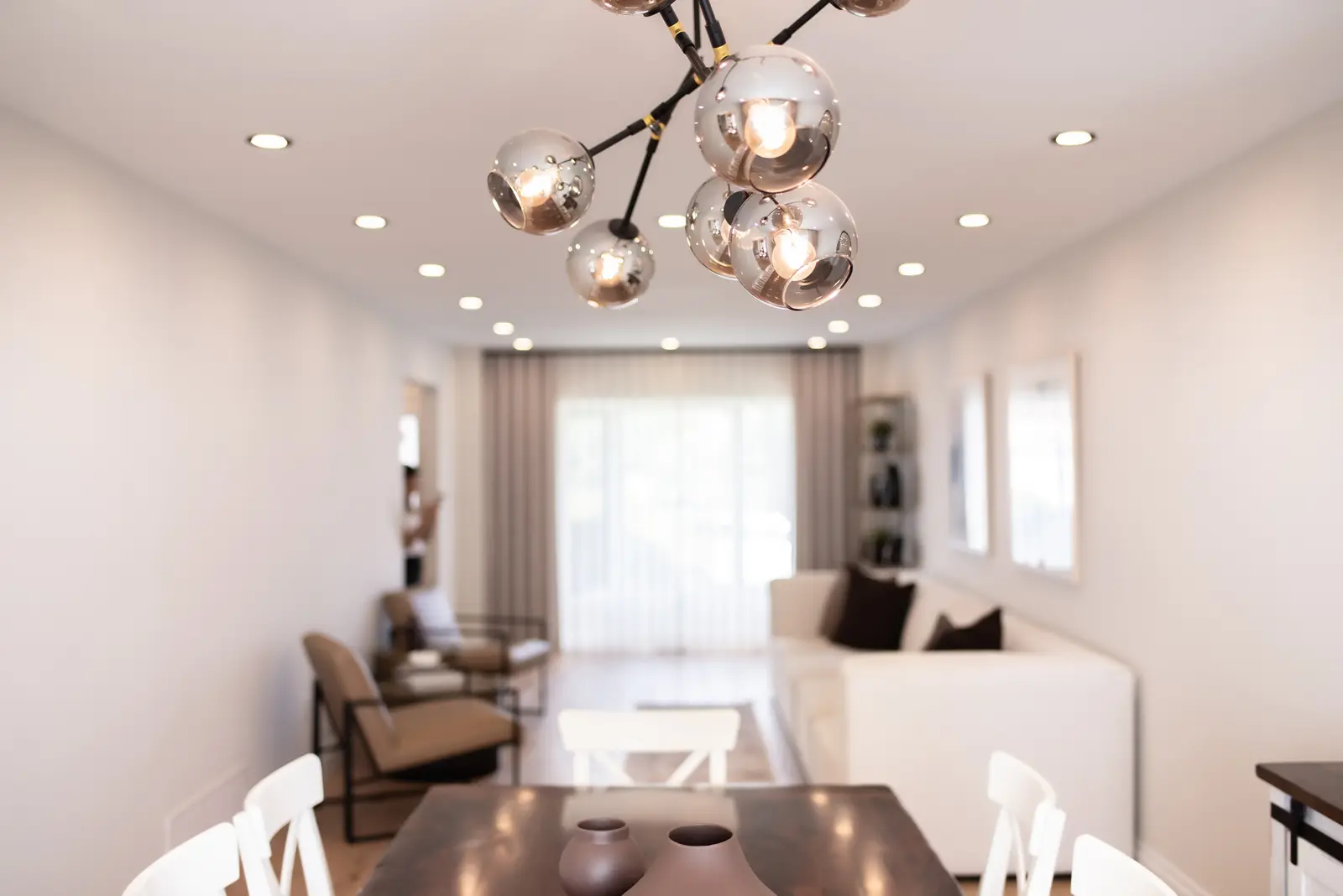 Interior of a Thornhill house renovation, with sage cabinetry, light wood floors, walnut, and brass fittings.