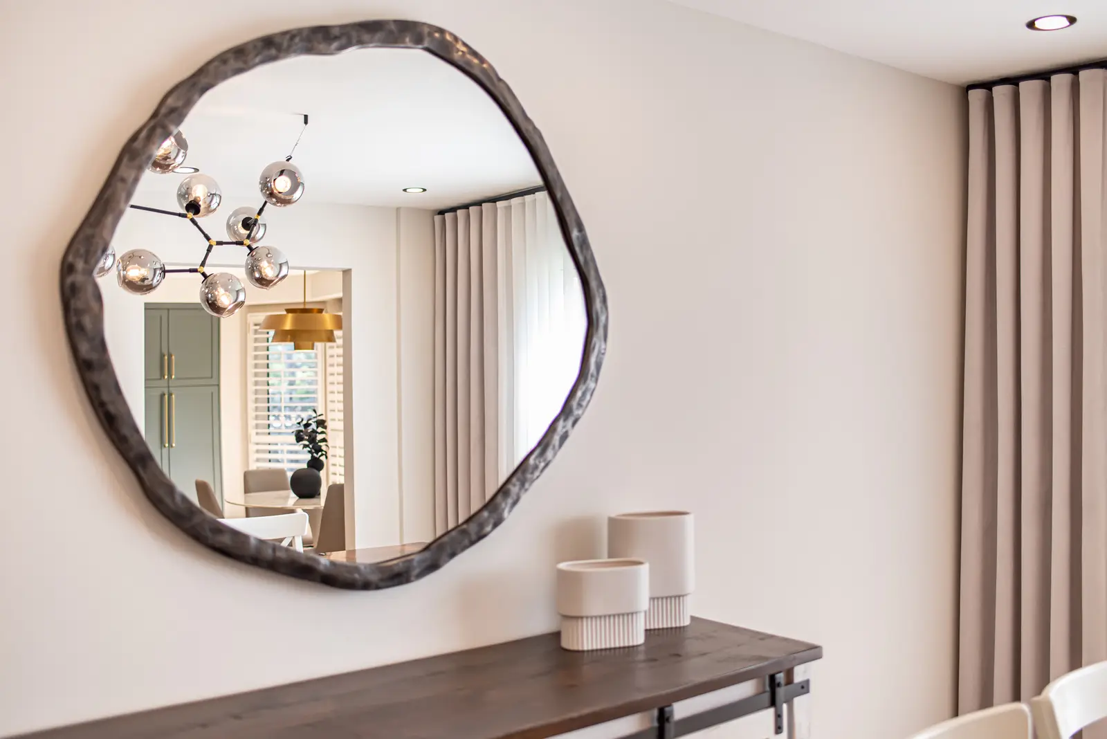 Interior of a Thornhill house renovation, with sage cabinetry, light wood floors, walnut, and brass fittings.