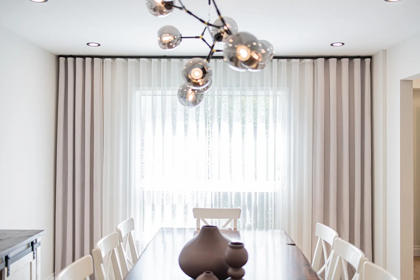 Interior of a Thornhill house renovation, with sage cabinetry, light wood floors, walnut, and brass fittings.
