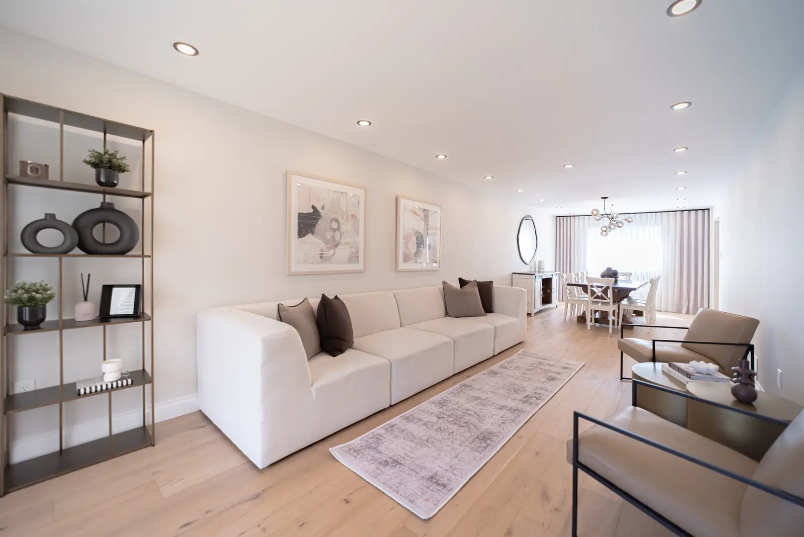 Interior of a Thornhill house renovation, with sage cabinetry, light wood floors, walnut, and brass fittings.