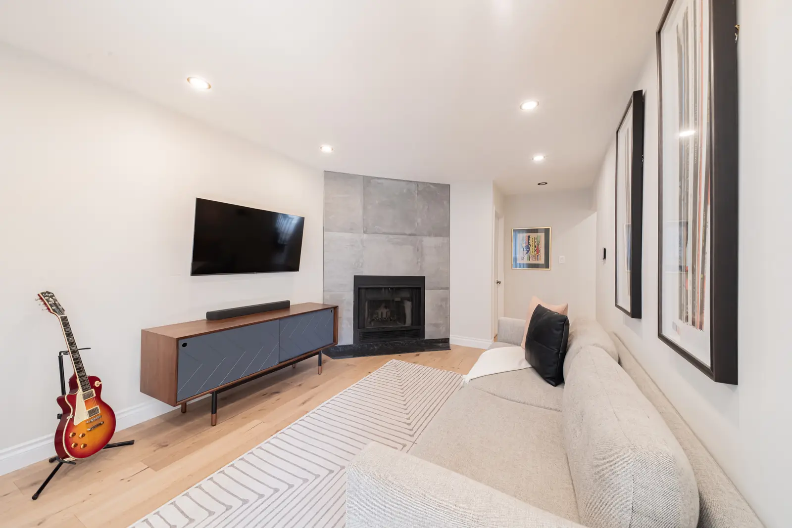 Interior of a Thornhill house renovation, with sage cabinetry, light wood floors, walnut, and brass fittings.